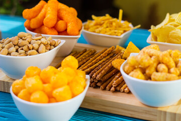 Party food. Salty snacks served as party food in bowls