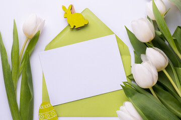 Template for Easter greeting card. Blank card with an envelope and bouquet of white tulips