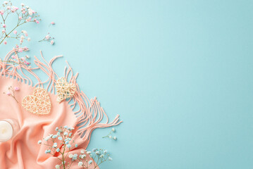Obraz premium Hello spring concept. Top view photo of two rattan hearts small candle in glass gypsophila flowers and pink scarf on isolated light blue background with copyspace