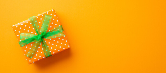 Saint Patrick's Day concept. Top view photo of giftbox in wrapping paper with polka dot pattern and...