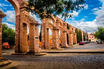 aqueduct with colonial architecture and blue sky, downtown of zacatecas  - obrazy, fototapety, plakaty
