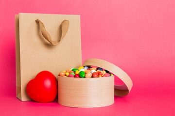 Shopping bag with gift box on colored background perspecrive view. Space for text holiday concept