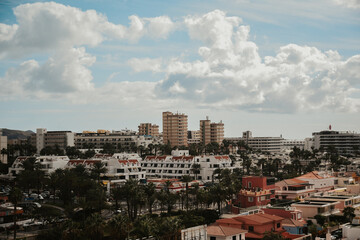 View from a drone, Tenerife, beach and city. Rest under palm trees, summer, resort, summer vacation, mountains.