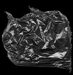 Naklejka premium Wrinkled plastic wrap texture on a black background wallpaper. Royalty high-quality free stock photo image of realistic plastic wrap for overlay, copy space and photo effect. Wrinkled plastic surface