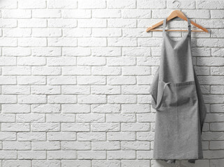 Clean kitchen apron with pattern on white brick wall. Space for text