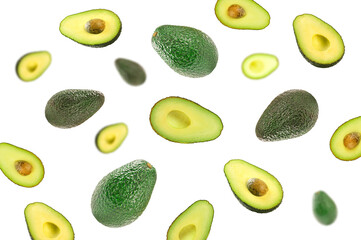 Avocado fruits falling in the air on white