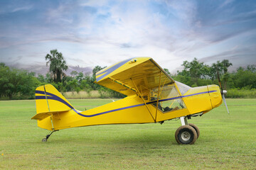 View of beautiful ultralight airplane in field on autumn day