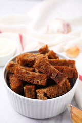 Crispy rusks and garlic on white marble table
