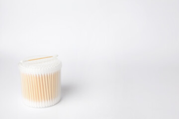 Fototapeta na wymiar New cotton buds in container on white background. Space for text