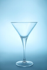 Elegant empty martini glass on light blue background