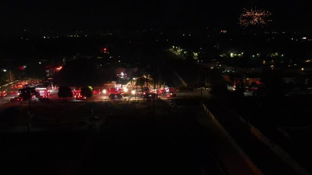 aerial view of a large emergency scene with flashing red lights 
