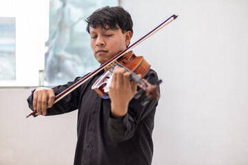 hispaic musician playing violin or viola. latin hispanic violin player playing viola or violin