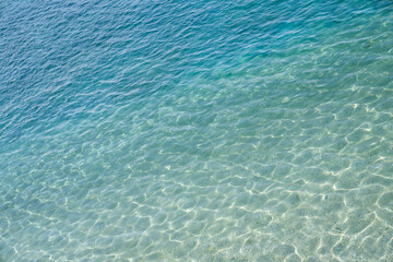 Plakat Background of marine water surface, sun's rays shimmer on water surface, diagonal lines, top view