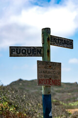 Directions wooden sign in Puquen National Park near valparaiso in Chile., Latinoamerica, Southamerica. Its a long treeking where you can find a cold geyser made from a natural formation in the sea.