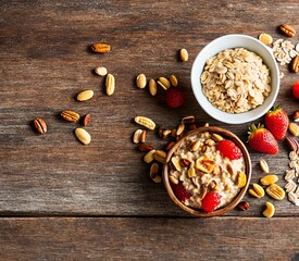 healthy breakfast concept. delicious blueberries and oatmeal with fresh berries and nuts on blue wooden background