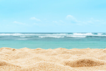 Fototapeta na wymiar Empty sandy beach in the background with a blurry summer sea.