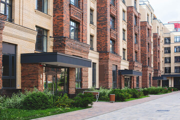Modern european residential apartment complex yard territory, multi-story house buildings with playground and benches, contemporary scandinavian housing development, facade exterior and courtyard