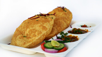Chole Bhature or Chick pea curry with Fried Puri served in a white ceramic plate