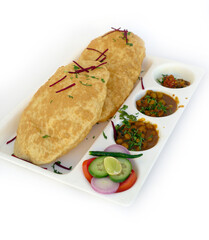 Chole Bhature, spicy Chick Peas curry also known as Chole or Channa Masala is traditional North Indian main course recipe and usually served with fried puri or Bhature, selective focus