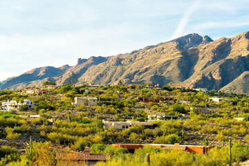 Ridge rilled with houses or homes in a mansion community in the hills of the sonora desert in arizona with visible moutains