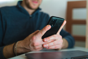 A young man is using his laptop at night for business or studying 