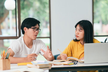 An asian students are reading books and study, Tutoring together.