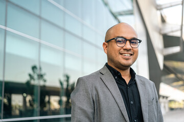 Senior manager business man in suit standing at the buildings downtown. Confident man arms crossed looking towards their goals for success. Executive business man