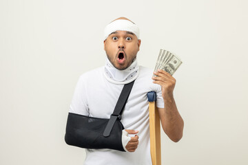 Happy young asian man broken arm holding Dollar banknote. Man put on plaster bandage cast splint. Male patient wearing sling support arm. life insurance and accident have money to spend while sick