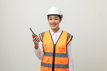 Asian engineer worker woman or architect with white safety helmet standing on isolated white background. Mechanic service factory Professional job occupation in uniform working with radio