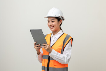 Asian engineer worker woman or architect with white safety helmet standing on isolated white background. Mechanic service factory Professional job occupation in uniform working with tablet