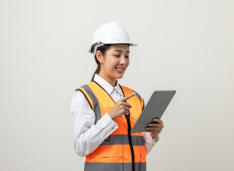 Asian engineer worker woman or architect with white safety helmet standing on isolated white background. Mechanic service factory Professional job occupation in uniform working with tablet