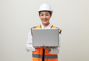 Asian engineer worker woman or architect with white safety helmet standing on isolated white background. Mechanic service factory Professional job occupation in uniform working with laptop computer