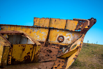 Rusty part of a fishing boat in the coast in a cloudy day