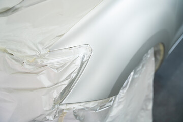 Car parts are in the process of car painting in chamber workshop. Automobile repair. Car Painter.