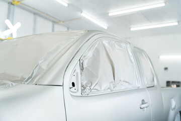 Close-up Car is in the process of car painting in chamber workshop. Automobile repair. Car Painter..