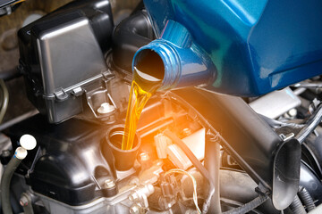 Refueling and pouring oil quality into the engine motor car Transmission and Maintenance Gear .Energy fuel concept.
