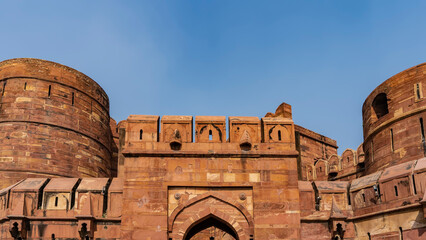 Fragment of the Red Fort in Agra. Fortress brick wall made of sandstone against the blue sky....