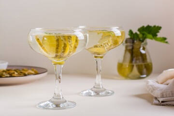 Cocktail with pickles in glasses on the table. Homemade drinks.