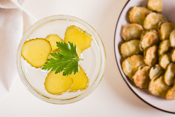 Cocktail with pickles in glasses on the table. Homemade drinks. Top view. Closeup