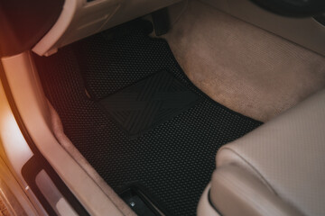 Driver-side black floor mats made of ethylene vinyl acetate shortened for EVA. Dark floor mats in...