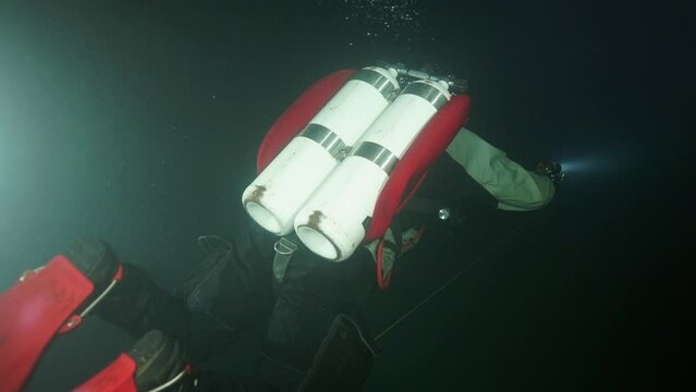 Budapest - 17 August 2017: Technical diver in red flippers in the underwater cave of Budapest