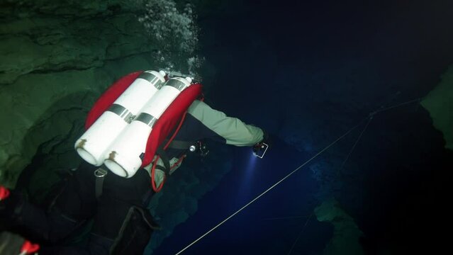 Budapest - 17 August 2017: Technical diver in red flippers in the underwater cave of Budapest