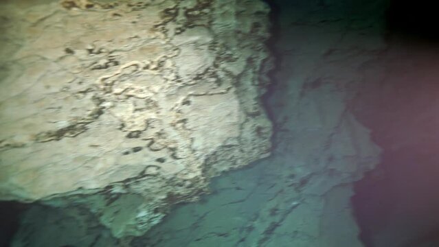 Budapest - 17 August 2017: Technical diver in red flippers in the underwater cave of Budapest