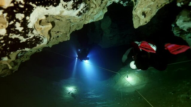 Budapest - 17 August 2017: Technical diver in red flippers in the underwater cave of Budapest