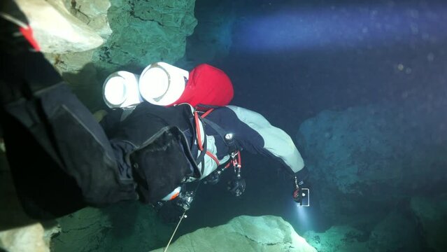 Budapest - 17 August 2017: Technical diver in red flippers in the underwater cave of Budapest