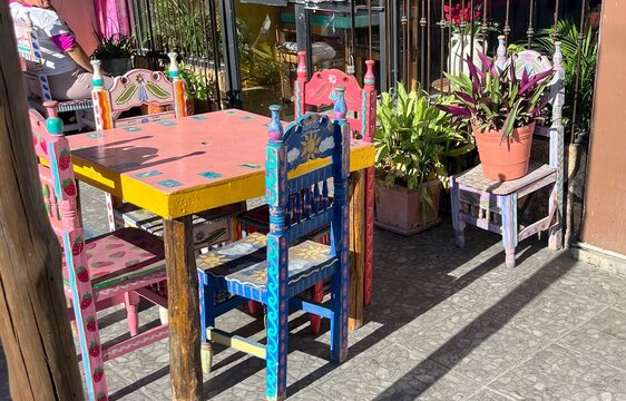 Colourful Mexican patio with hand painted tables and chairs