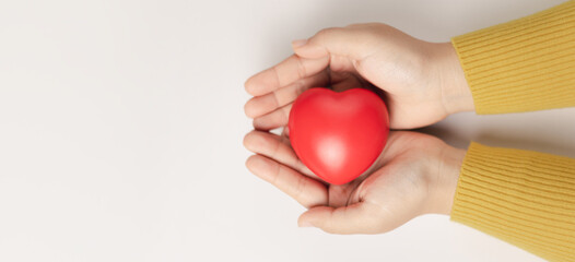 Woman hands holding red heart, love, health care, world mental health day, organ donation, mindfulness, wellbeing, world heart day, world health day, praying concept, family insurance and CSR concept.