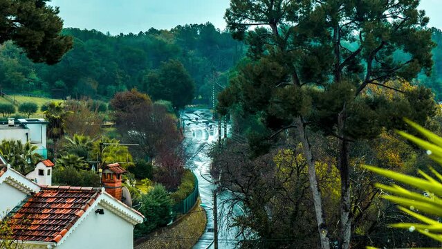 Rainy road with traffic on a cloudy day, suburbs, daytime, time lapse, Biot, France, 4K