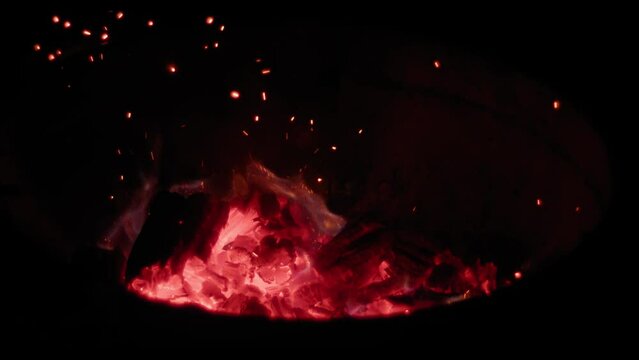 Embers rise by weber being moved. Filmed with a Blackmagic Pocket Cinema Camera 6K Pro.
