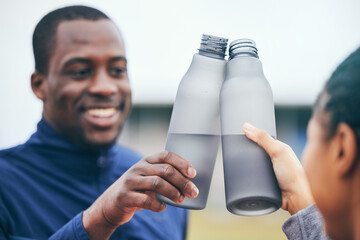 Fitness, water bottle and black couple toast outdoors together after workout, exercise or training....